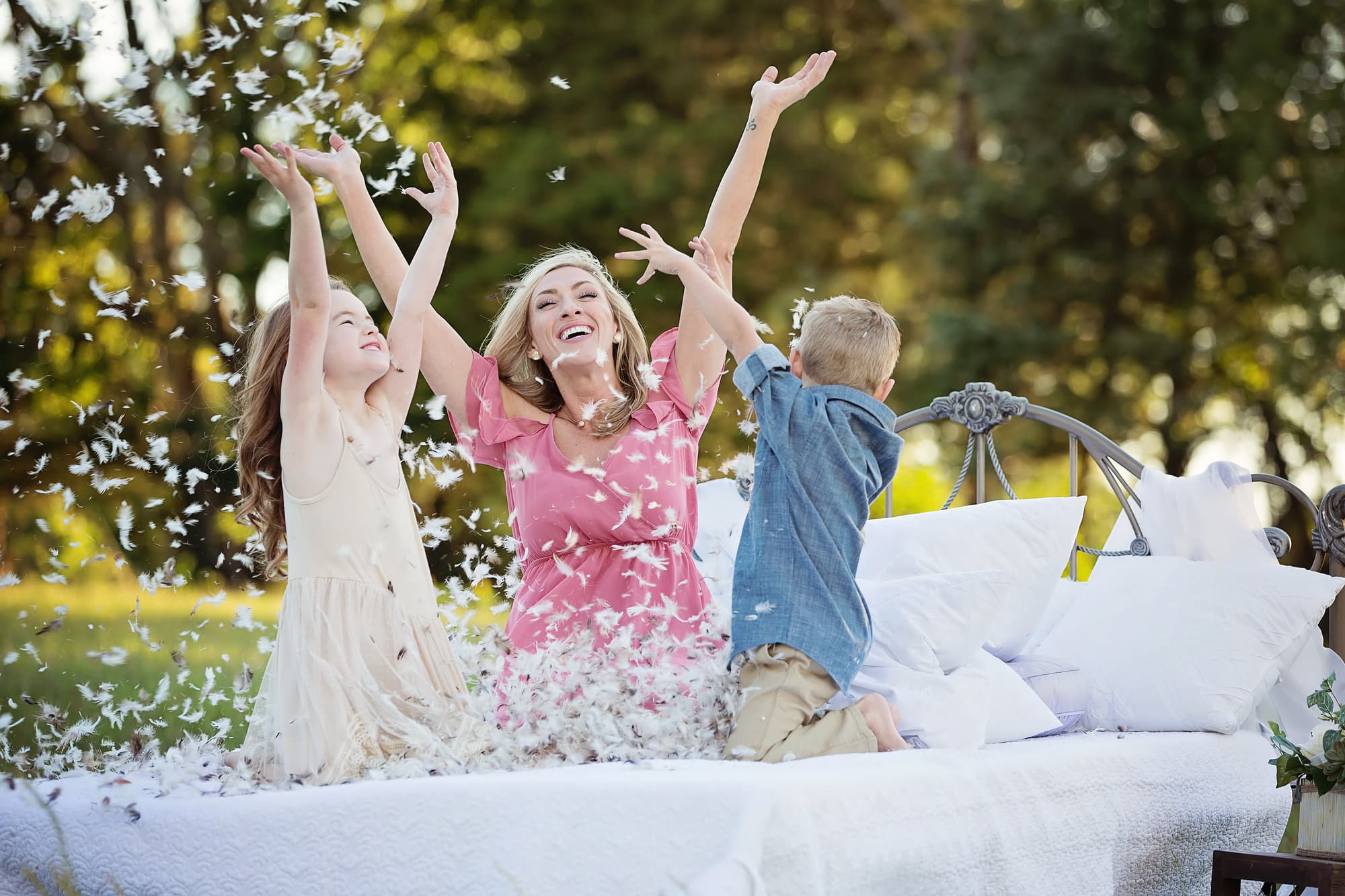 family feather pillow fight in field